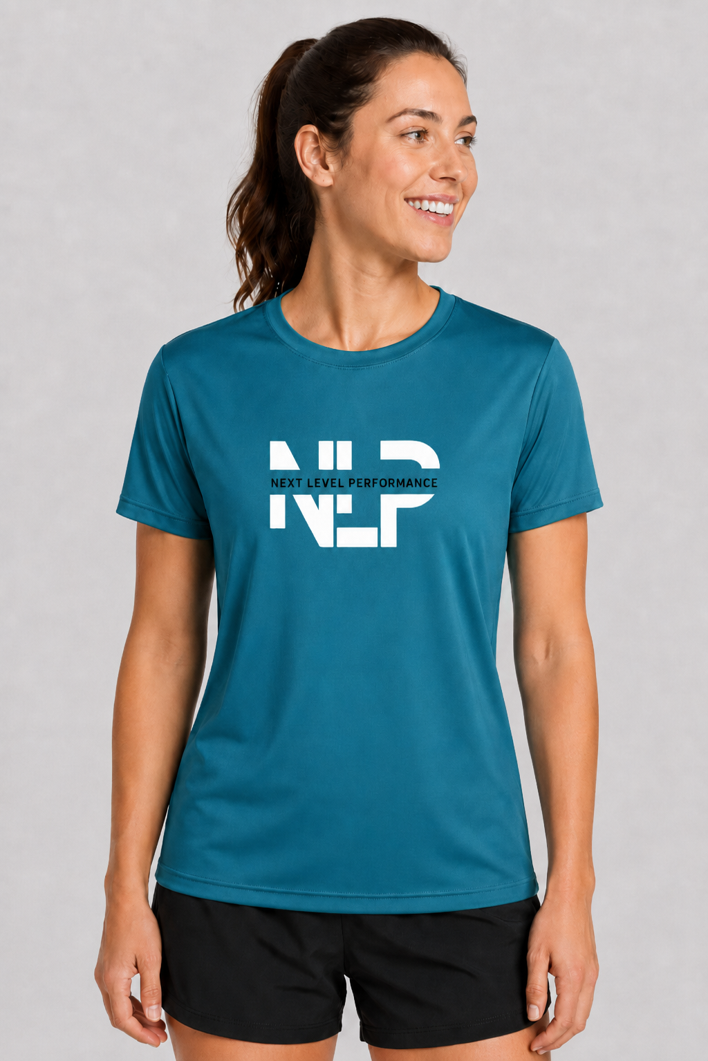 Woman wearing teal Next Level Performance Softball team shirt