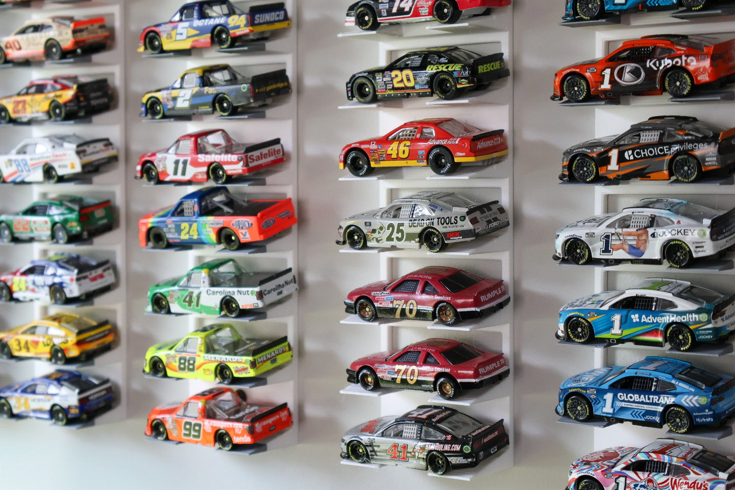 Angled view of RAM Designz 1/64 scale NASCAR wall display stands with diecast cars