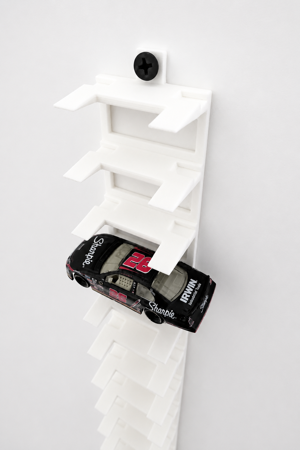 Angled view of 1/64 scale NASCAR wall display holding a diecast car