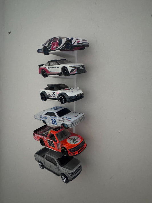 Universal floating diecast wall display holding six different 1/64 and 1/87 scale vehicles