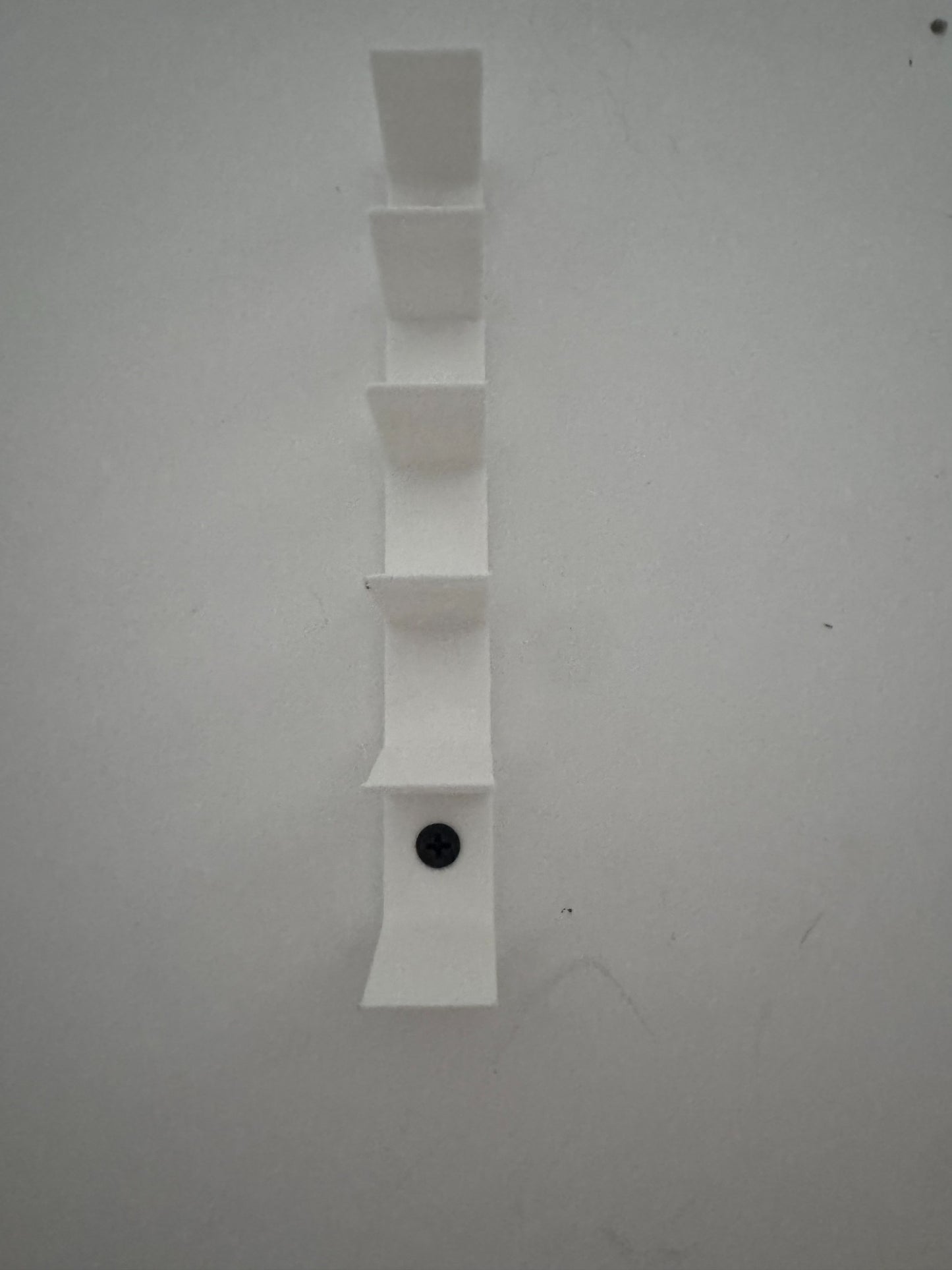 Empty universal floating diecast wall display showing six minimalist vehicle slots