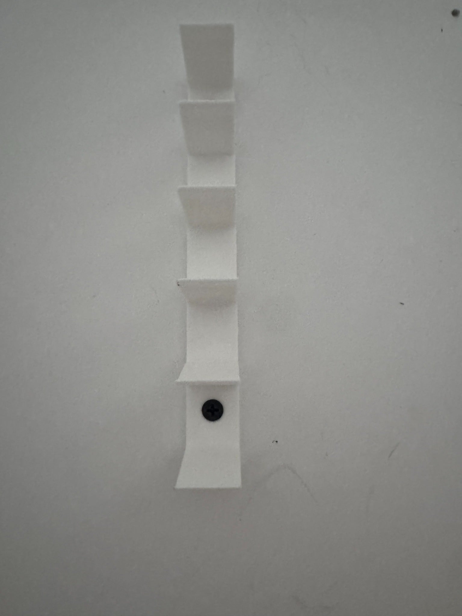 Empty universal floating diecast wall display showing six minimalist vehicle slots