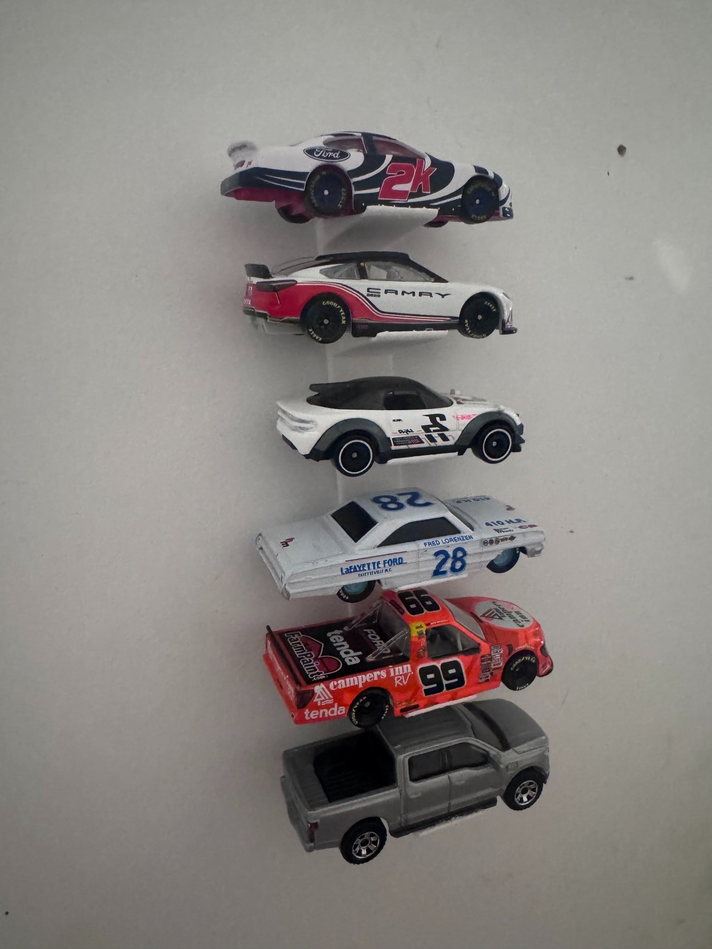 Side view of universal floating diecast wall display with six vehicles