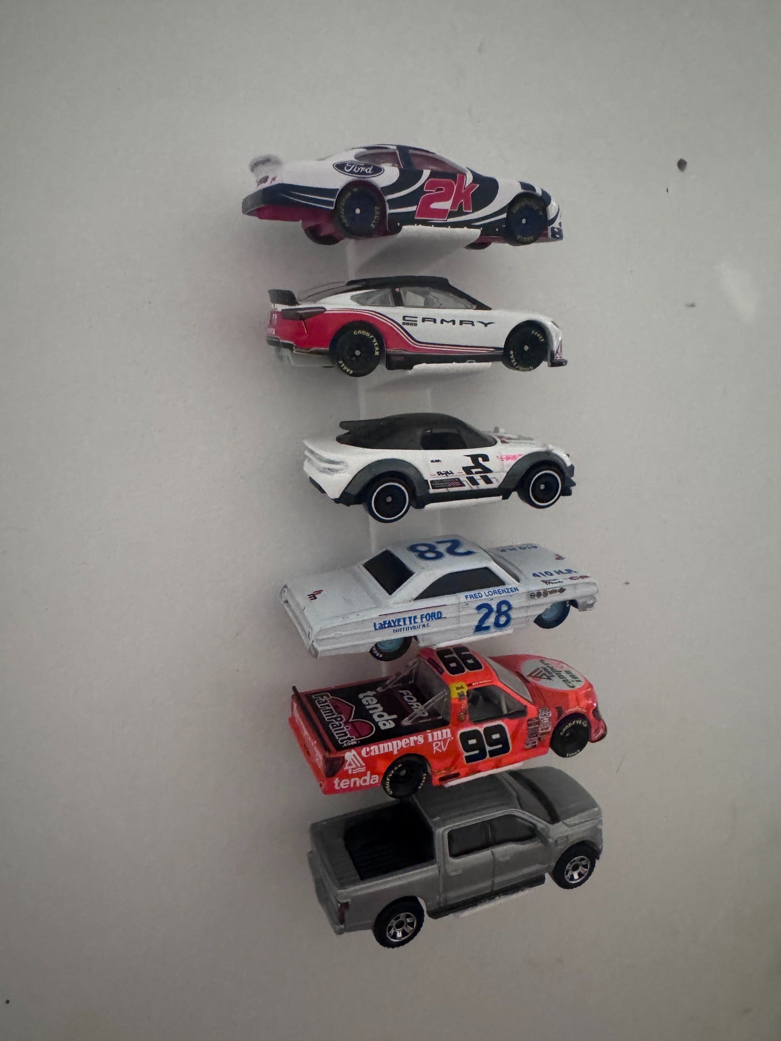 Side view of universal floating diecast wall display with six vehicles