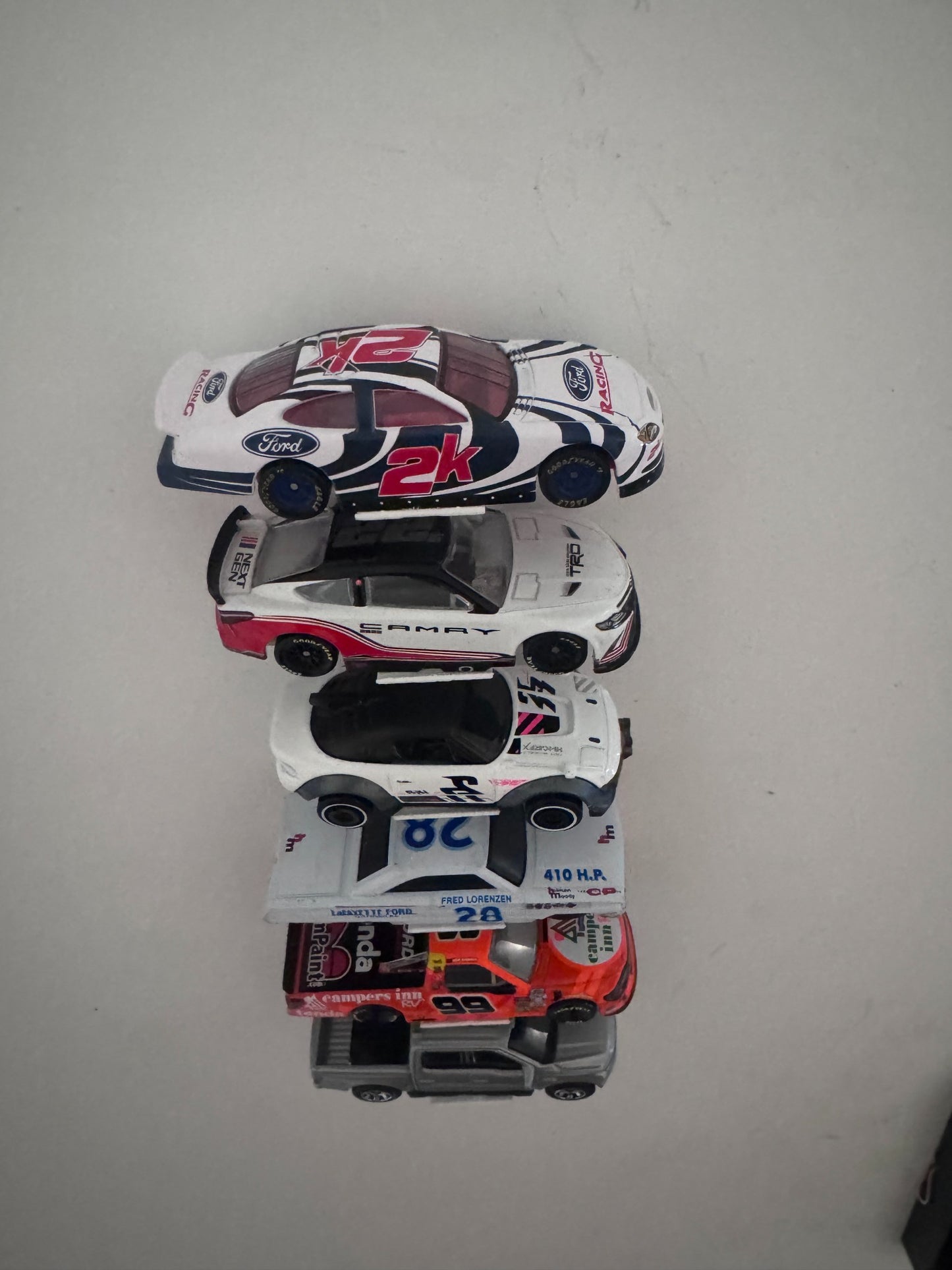 Front underside view showing the universal display supporting different diecast vehicle widths and body styles